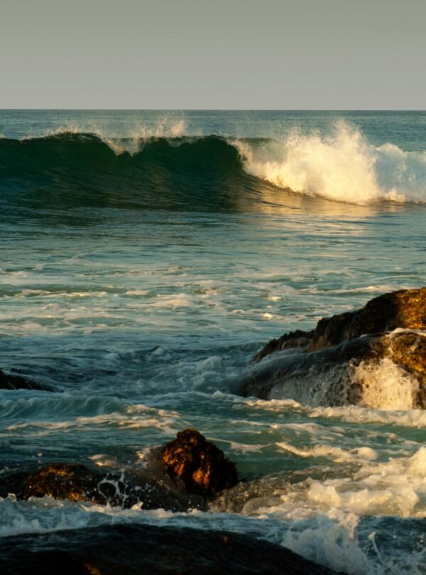 Tranquil seascape featuring waves crashing over rocks at Unawatuna beach in Sri Lanka.